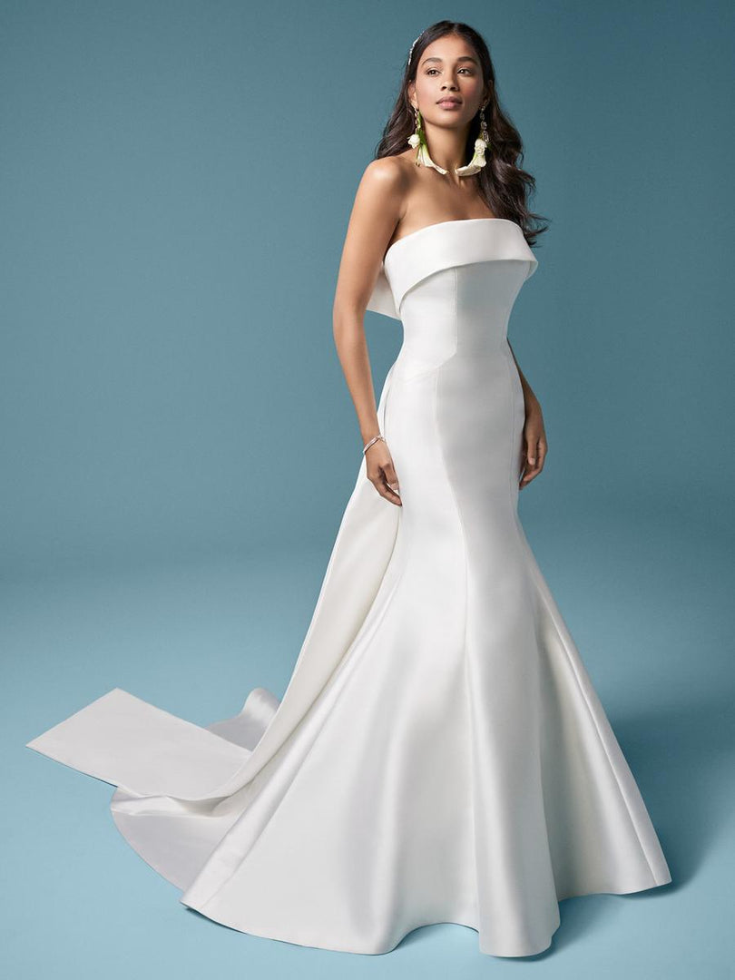 maggie sottero green dress Meet Taryn by Maggie Sottero Designs This strapless black mermaid is perfect for the bride who's seeking a simple black dress The ruffle bottom gives off Hollywood Glamour vibes #wildrosebridal